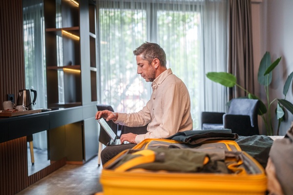 Man working on tablet in hotel room
