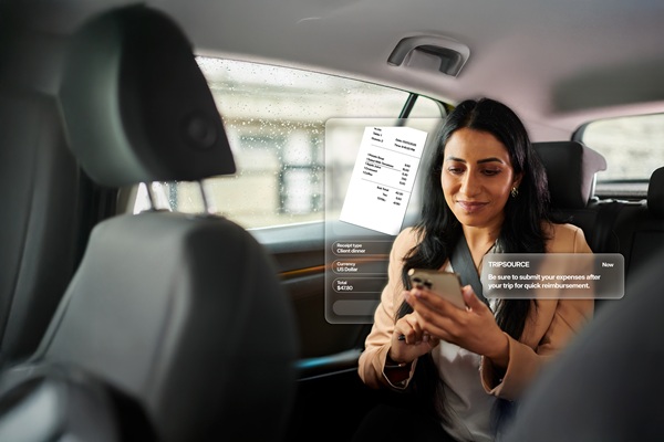 Woman using smartphone in car with receipt hologram.