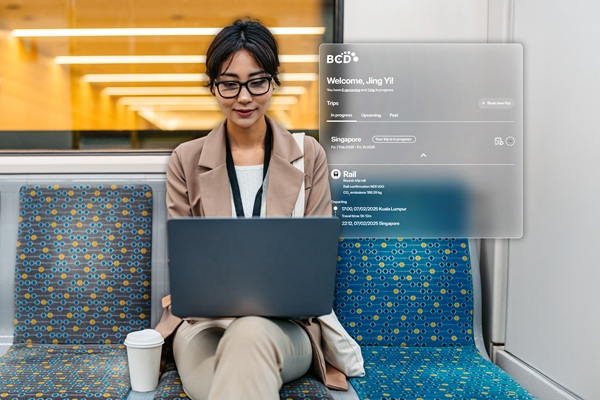 Woman on train using laptop with travel dashboard overlay
