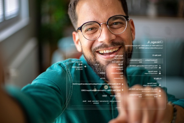 Smiling man using transparent digital touchscreen interface