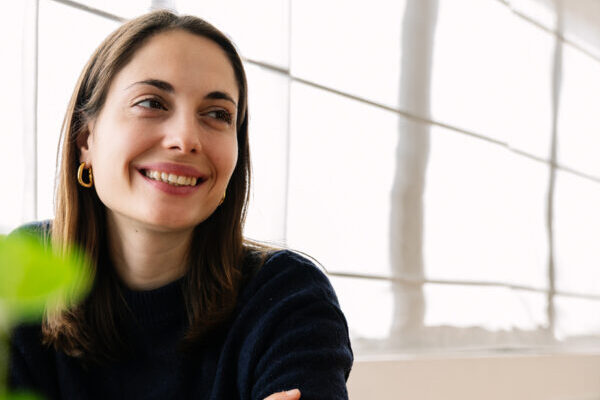 Smiling woman sitting at desk by window