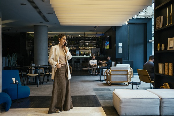 Woman on phone in modern hotel lobby