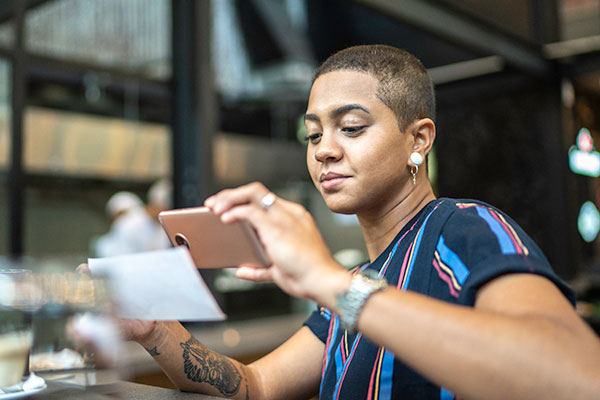 Woman making a photo of her receipt for her expense claim