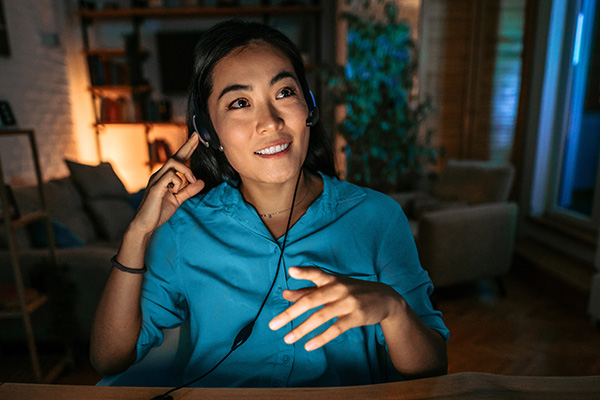 Woman with headset providing after-hours travel emergency support to customers