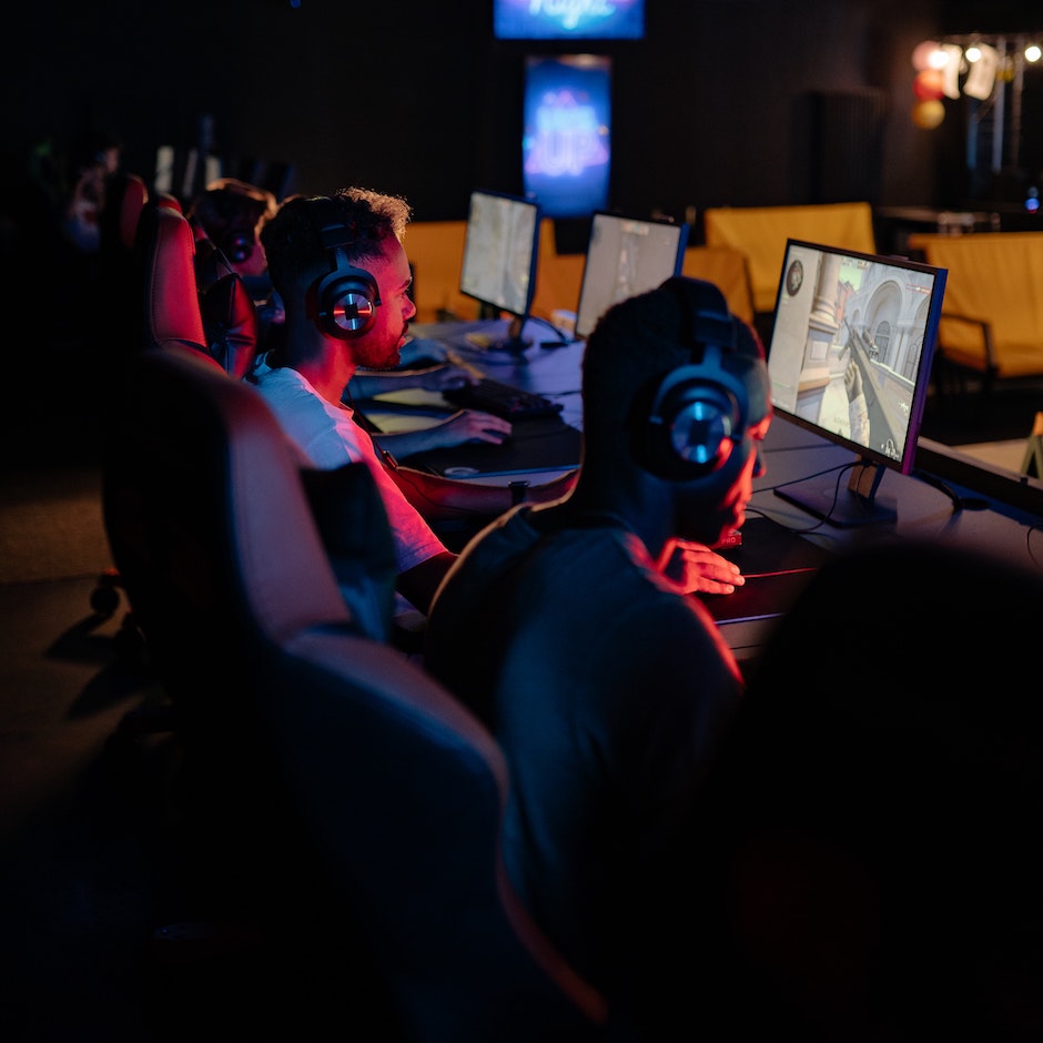 Gamers wearing headsets compete at computer stations