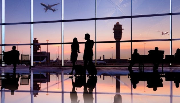 Luchthaven zonsondergang, silhouetten reizigers en vliegtuigen.