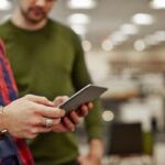 Two people discussing with a tablet in office.