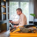 Man working on tablet in hotel room