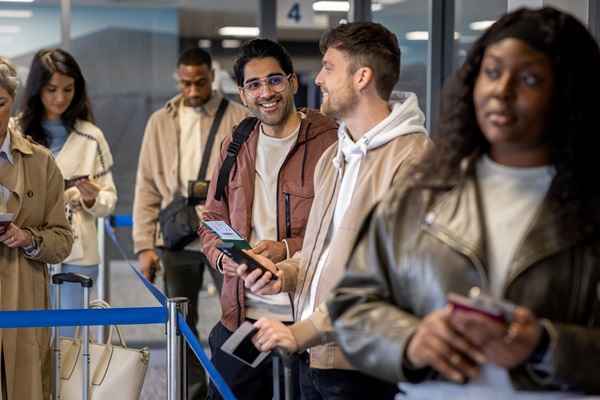 People waiting in line at airport check-in.