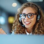 Smiling woman with headset ready to assist