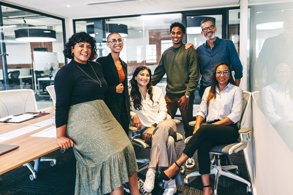 Team of coworkers posing in modern office
