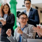 Group of professionals laughing during a meeting.