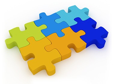 Verschillende gekleurde puzzelstukjes in elkaar gelegd.