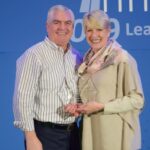 Twee mensen met een prijs op een evenement