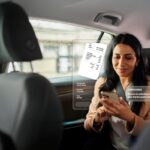 Woman using smartphone in car with receipt hologram.