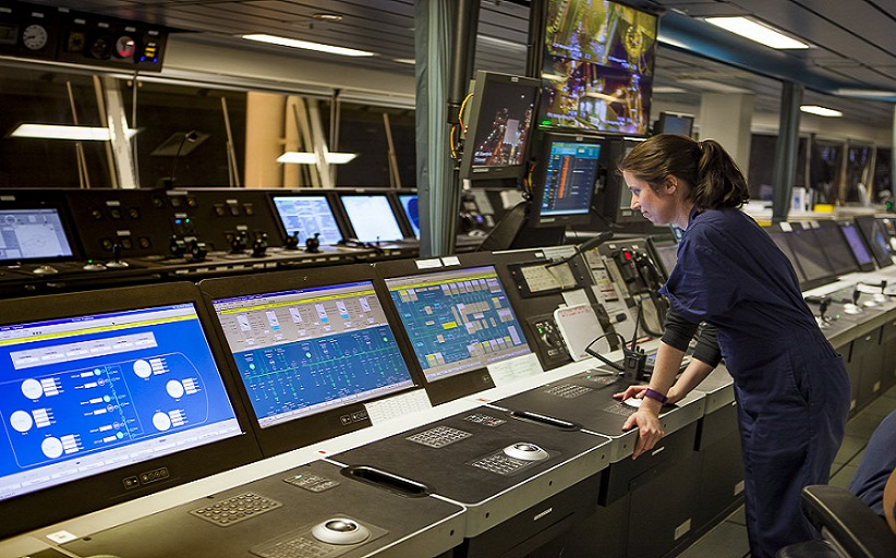Engineer monitors ship's control room technology systems.