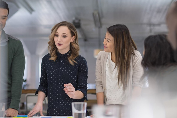 Colleagues collaborating around a table in a modern office