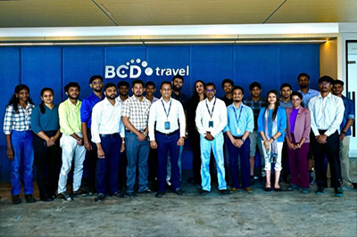BCD Travel team posing in front of company sign