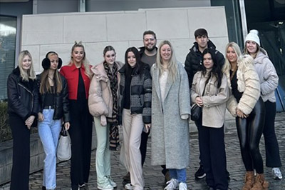 Group of friends posing outside a modern building