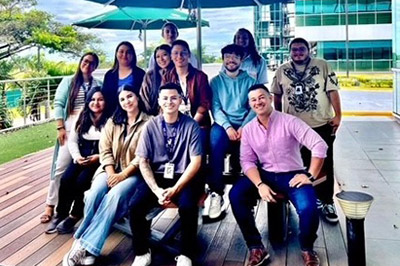 Diverse group of coworkers posing outdoors on a patio