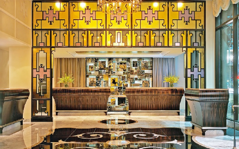 Luxurious hotel lobby with elegant decor and chandeliers.