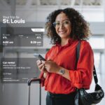 Woman at airport with travel itinerary display.
