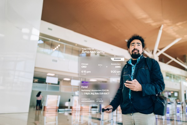 Traveler at airport with flight information display.