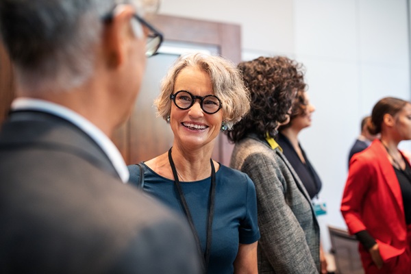 Professional woman smiling during business networking event