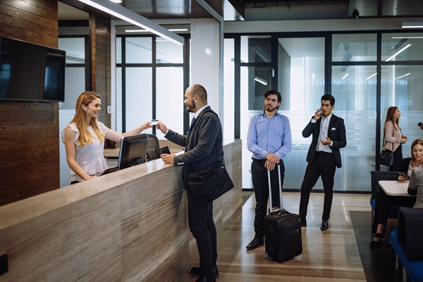 People waiting in line at a reception desk