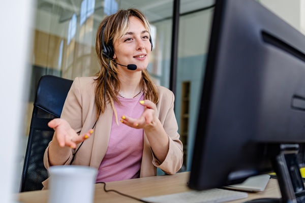 Customer service representative with headset at computer