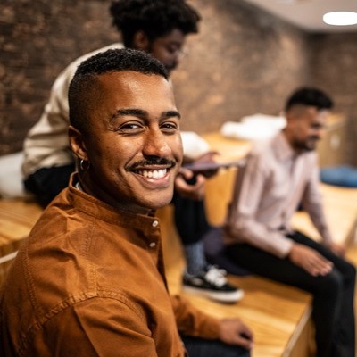 Smiling man in casual meeting setting.