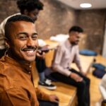 Group of friends smiling and chatting indoors.