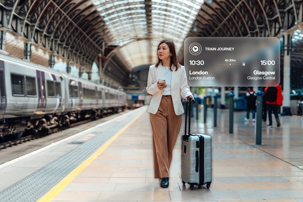 Woman at train station with suitcase