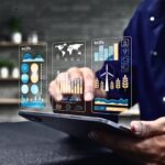 Person using digital tablet with data analytics graphs