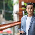 Man holding tablet in outdoor setting