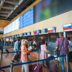 People checking in at airport counter.