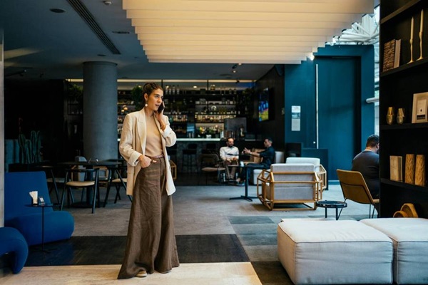 Woman in modern hotel lobby talking on phone