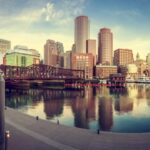 Boston skyline with waterfront views at sunset.