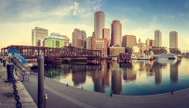 Boston skyline with waterfront views at sunset.