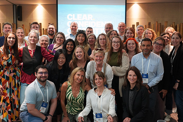 Group of people smiling at a conference.