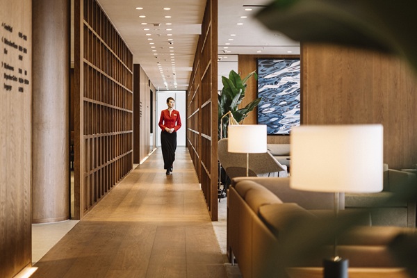 Woman walking through modern office hallway