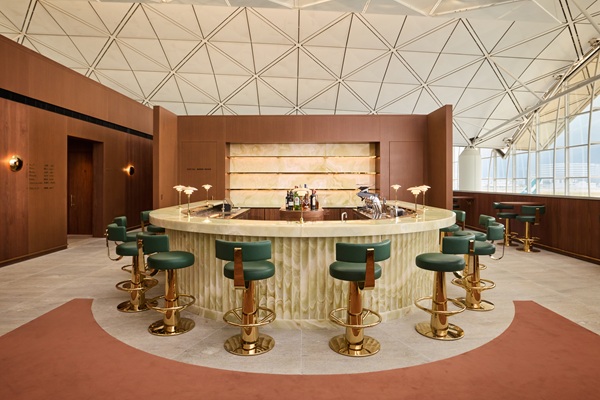 Circular marble bar with green leather stools