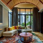 Luxurious hotel suite with modern decor and city view.