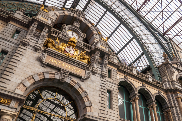 Ornate Antwerp Central Station facade beneath glass roof