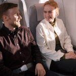 Happy passengers sitting together on an airplane.