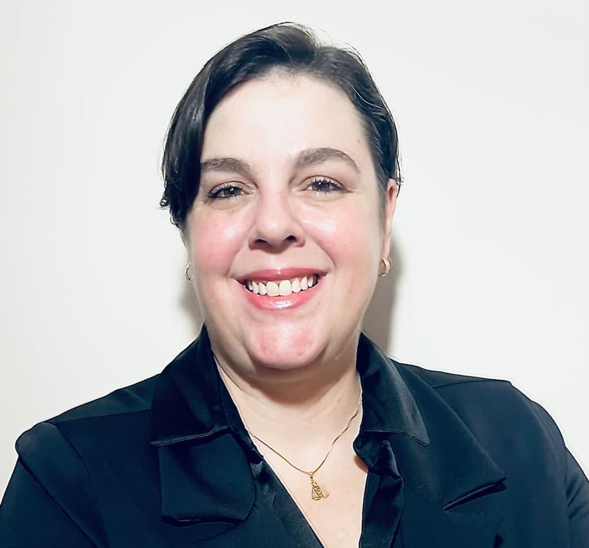 Smiling woman in black blazer against white background