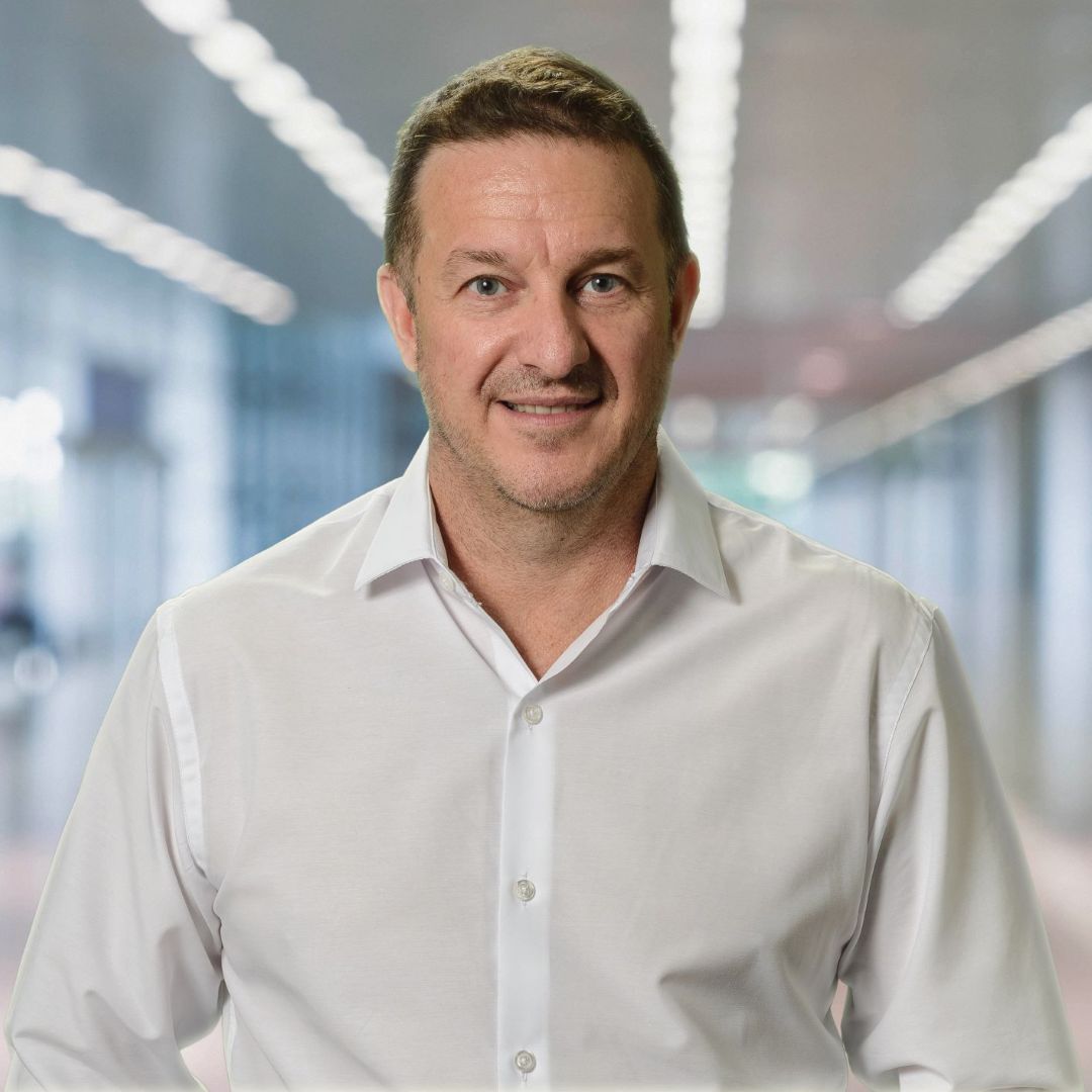 Smiling man in white shirt in modern office