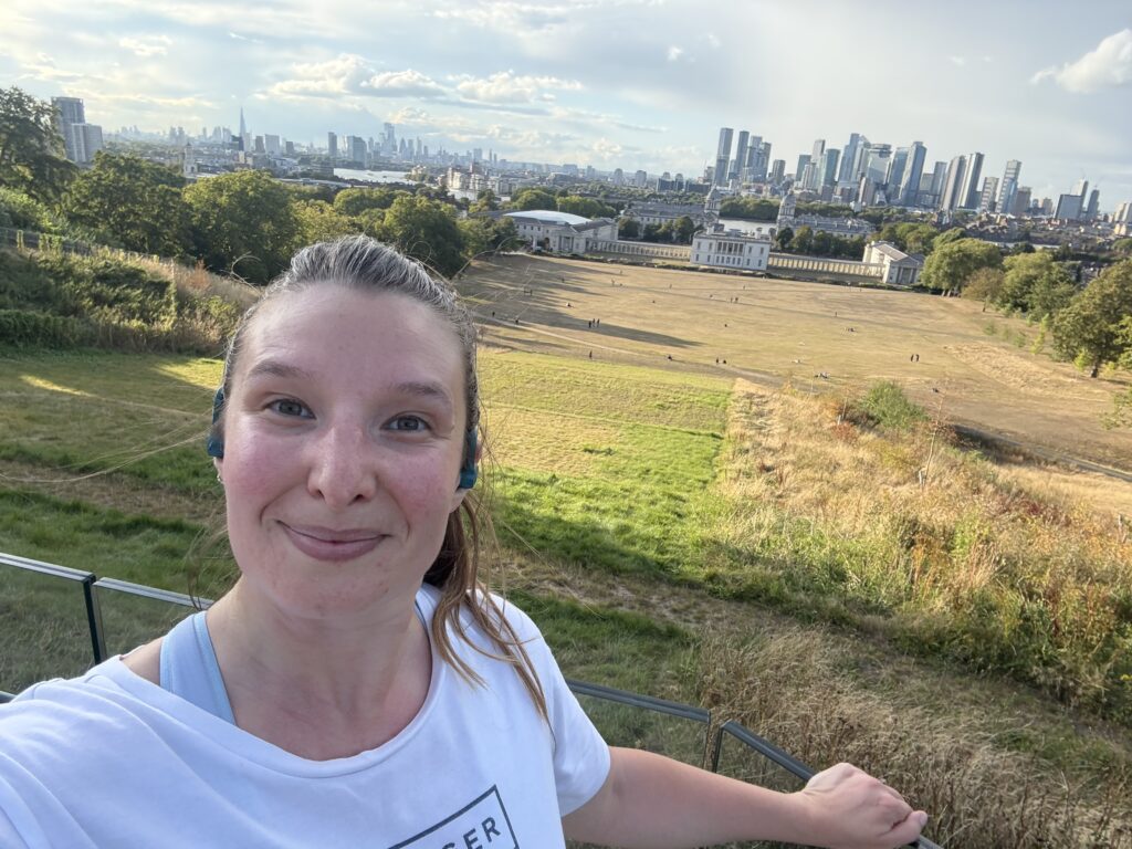 Person smiling, scenic city and park view background.