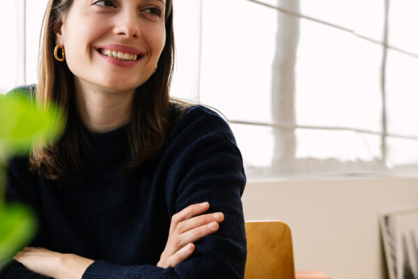 Smiling woman sitting at desk by window