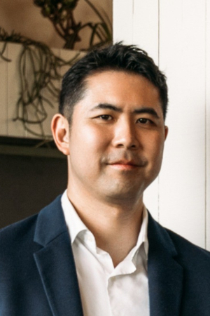 Man in suit smiling in office setting